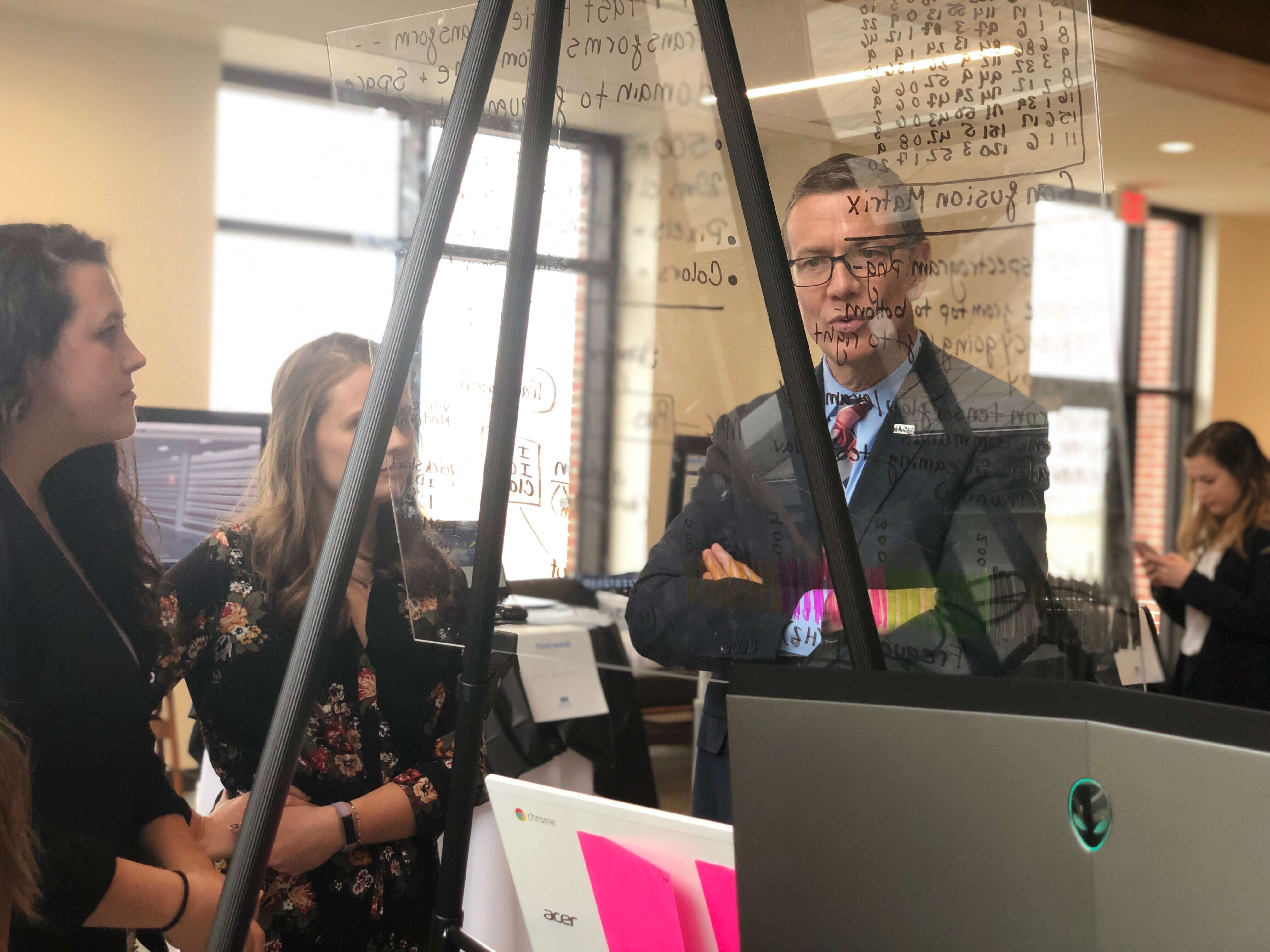 UNE president and students in the Makerspace.