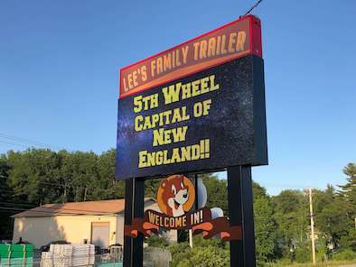 black billboard reading "lee's family trailer"