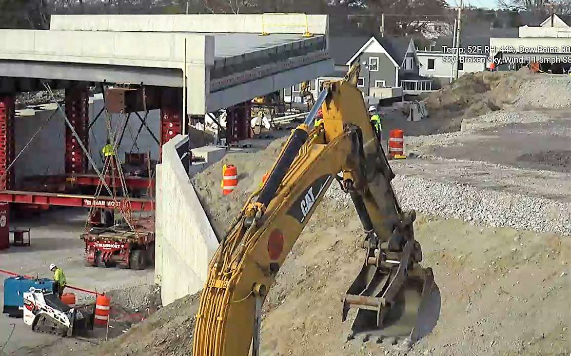 bridge section near two abutments, with yellow crane arm in foreground