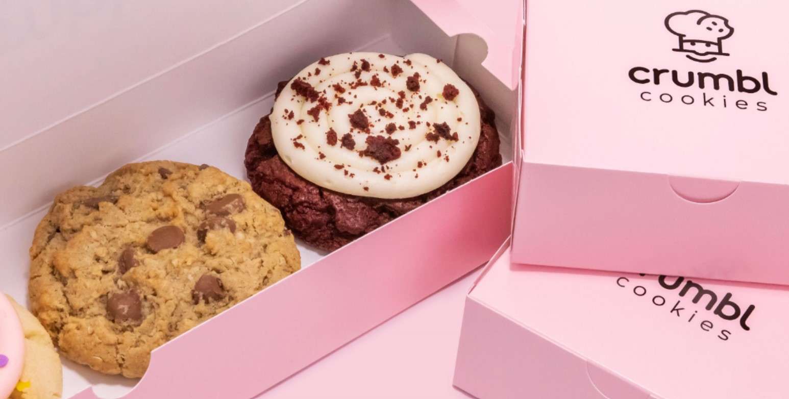 two cookies in a pink box and two pink boxes