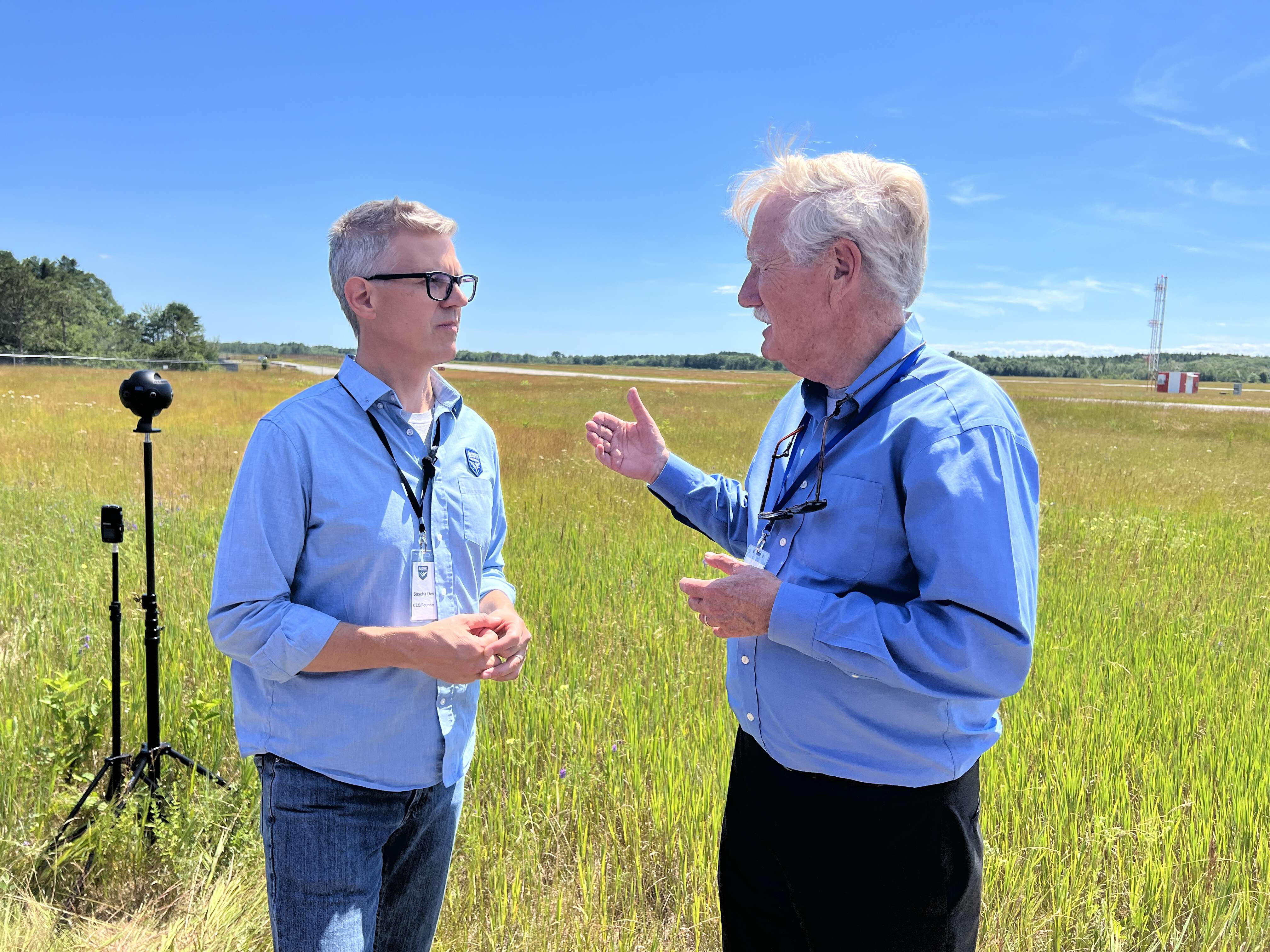 2 people talking in field