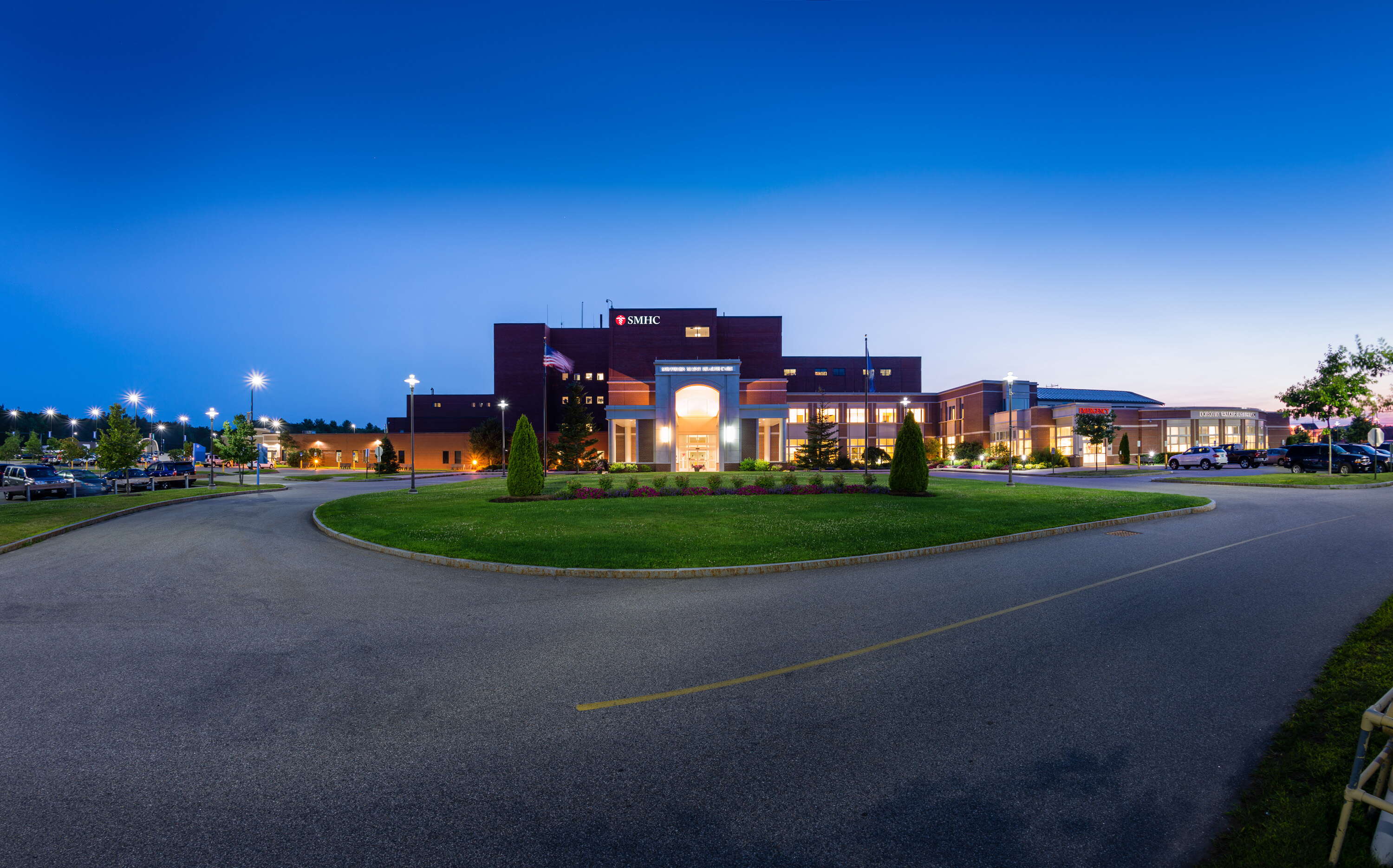 The Southern Maine Health Care building has lights on at night.