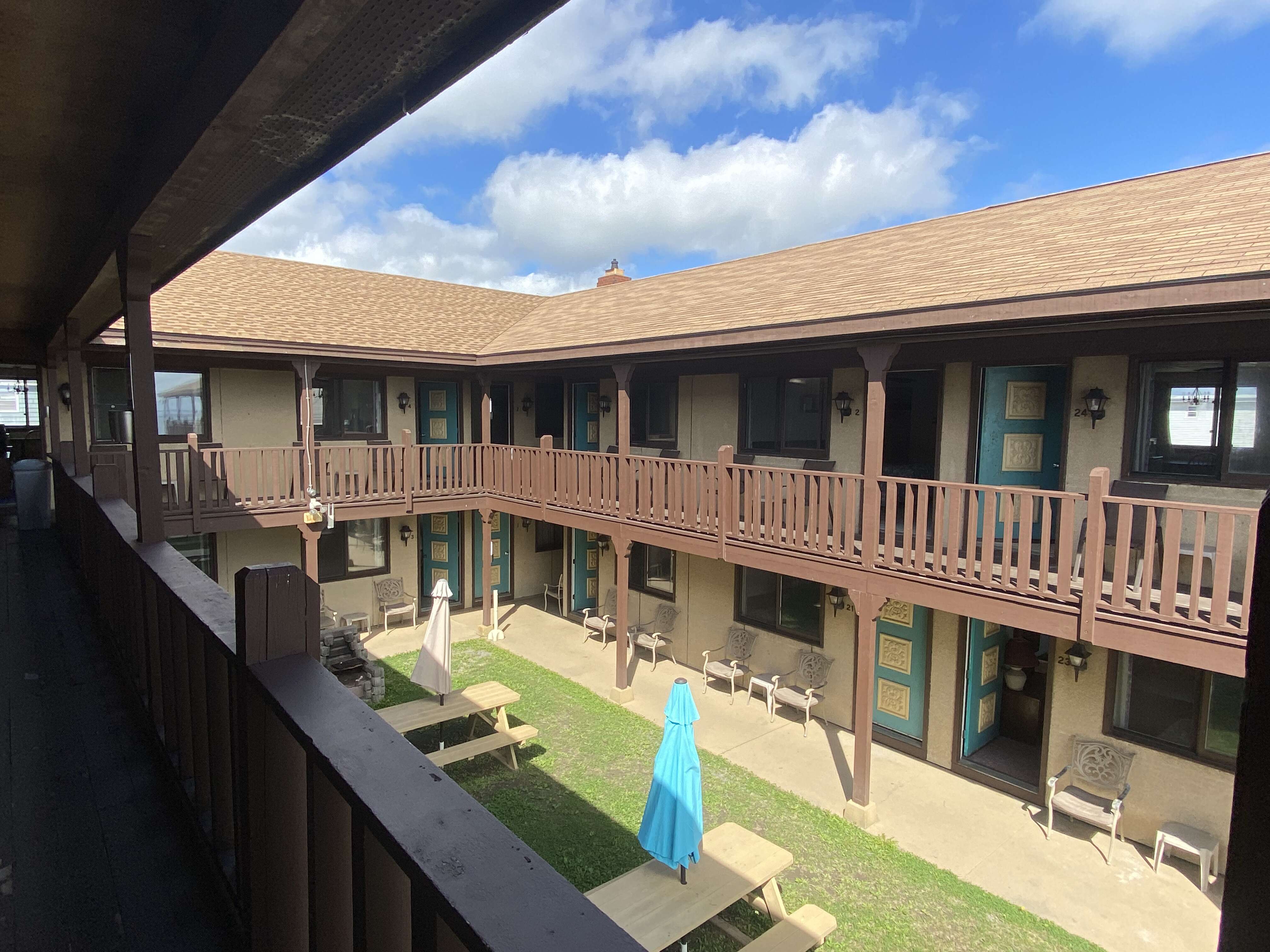 courtyard and blue umbrella with picnic tables