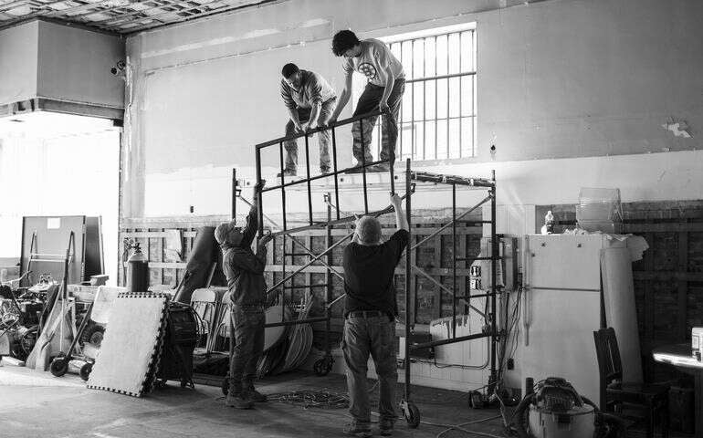 black and white photos of people on scaffolding