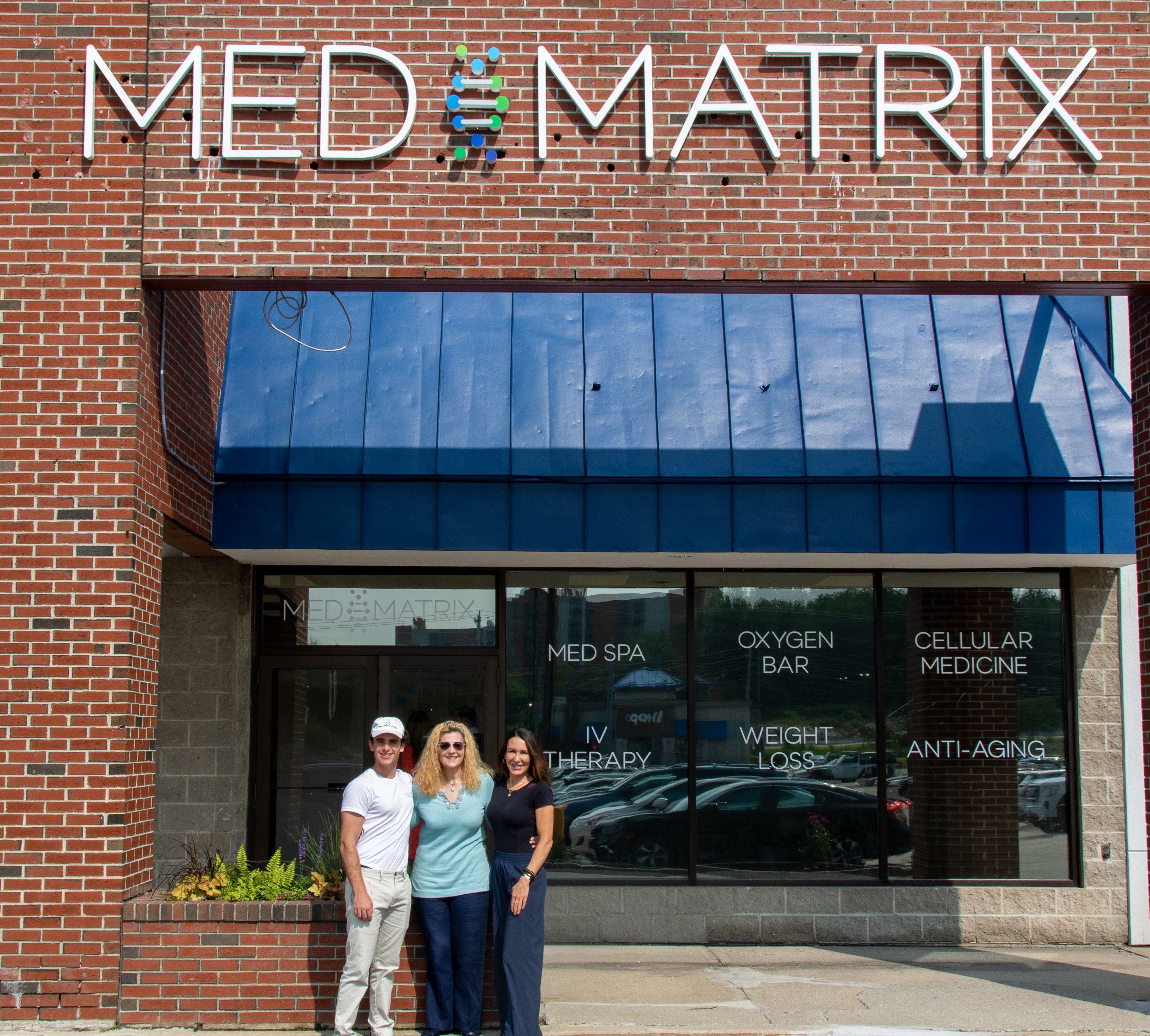 3 people outside store window