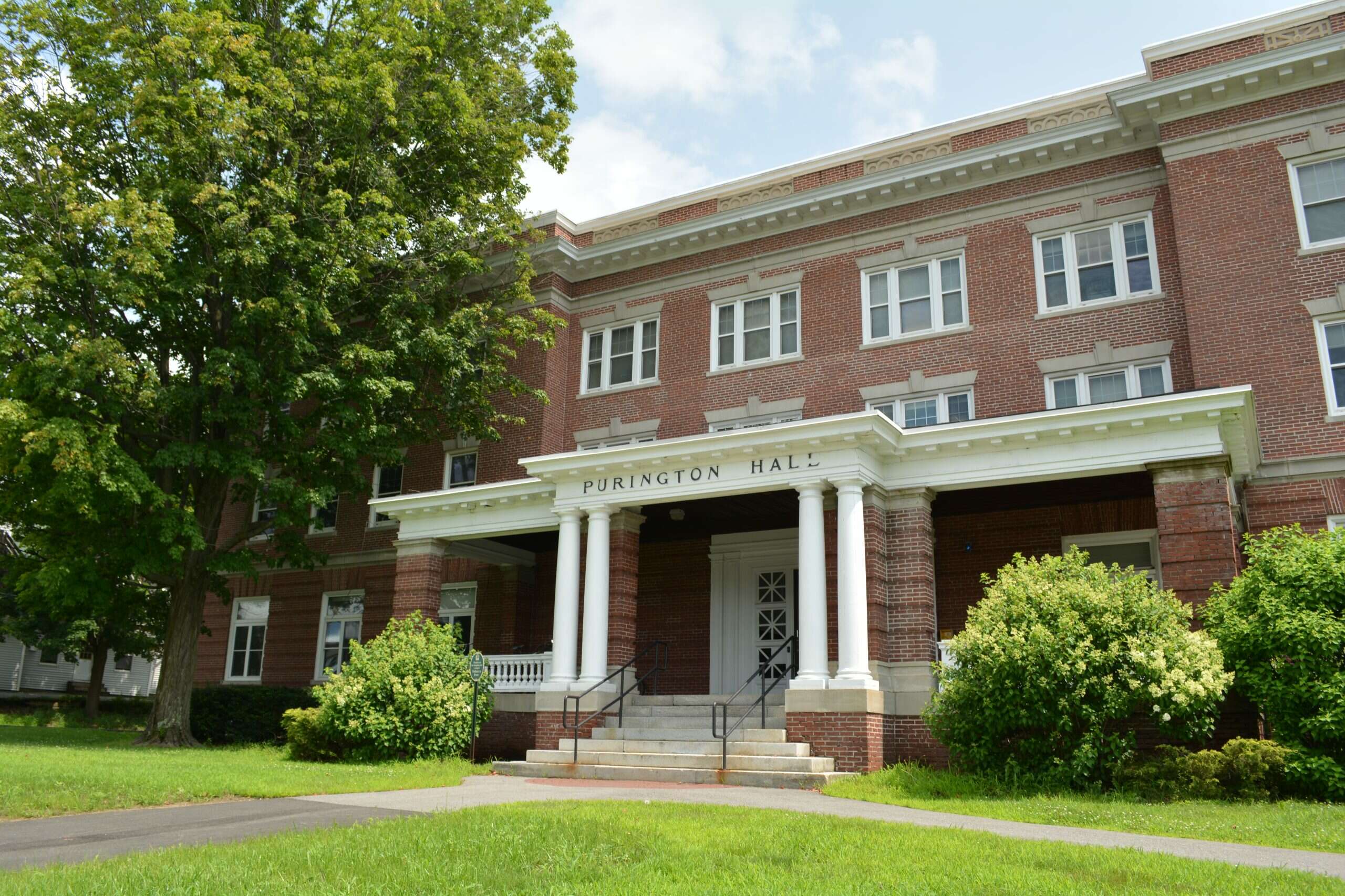 brick building with white columns