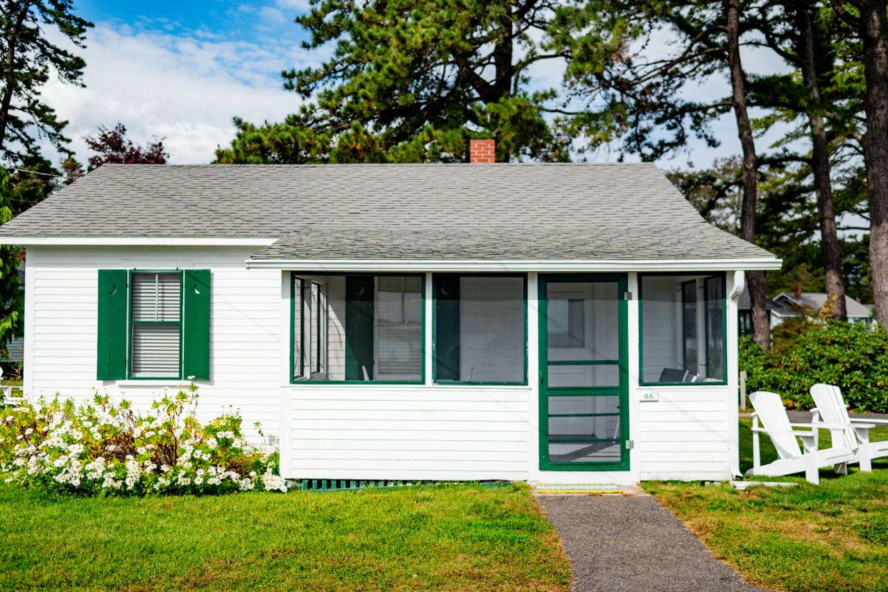 small white house with green trim