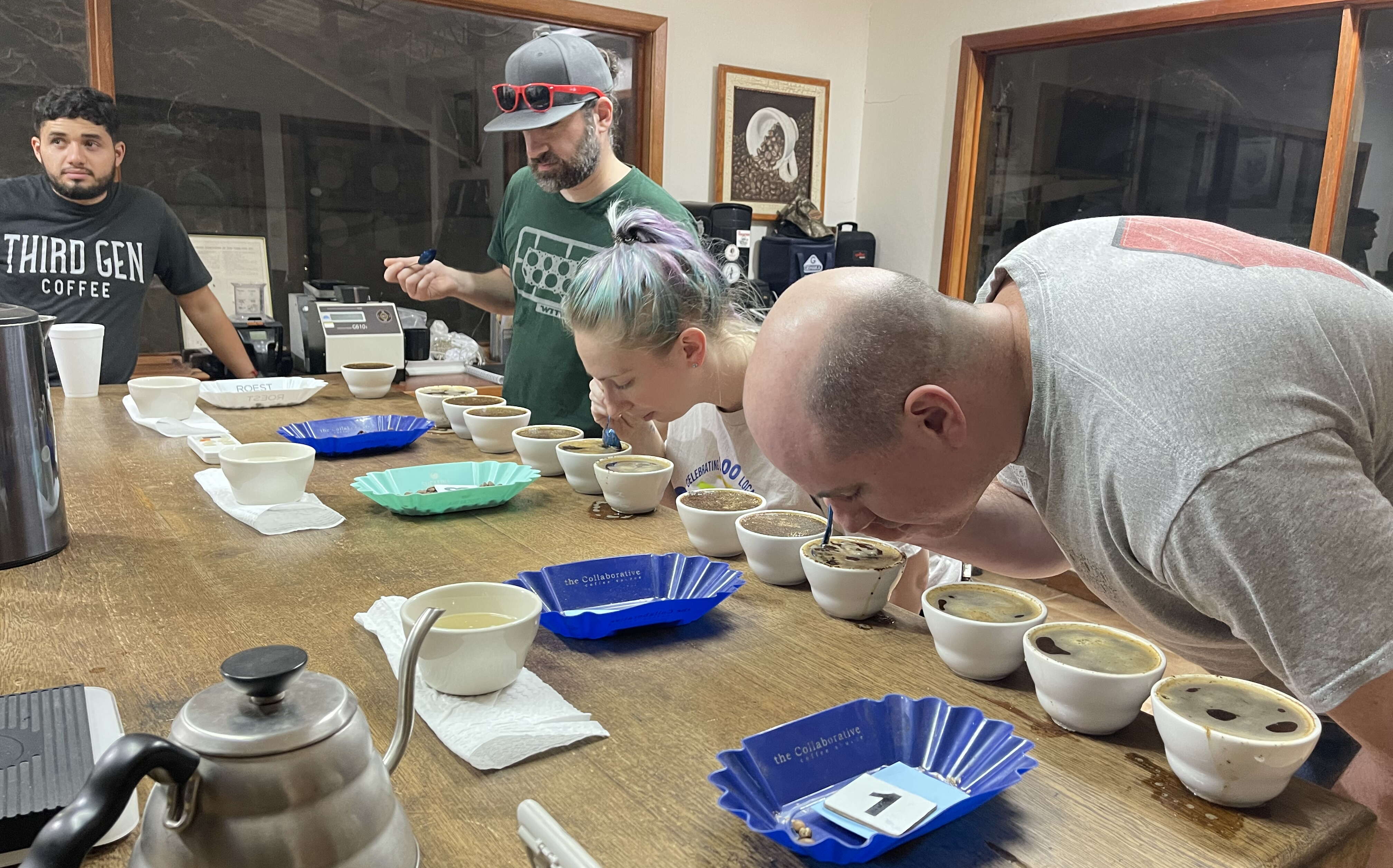 3 people sniffing cups of coffee