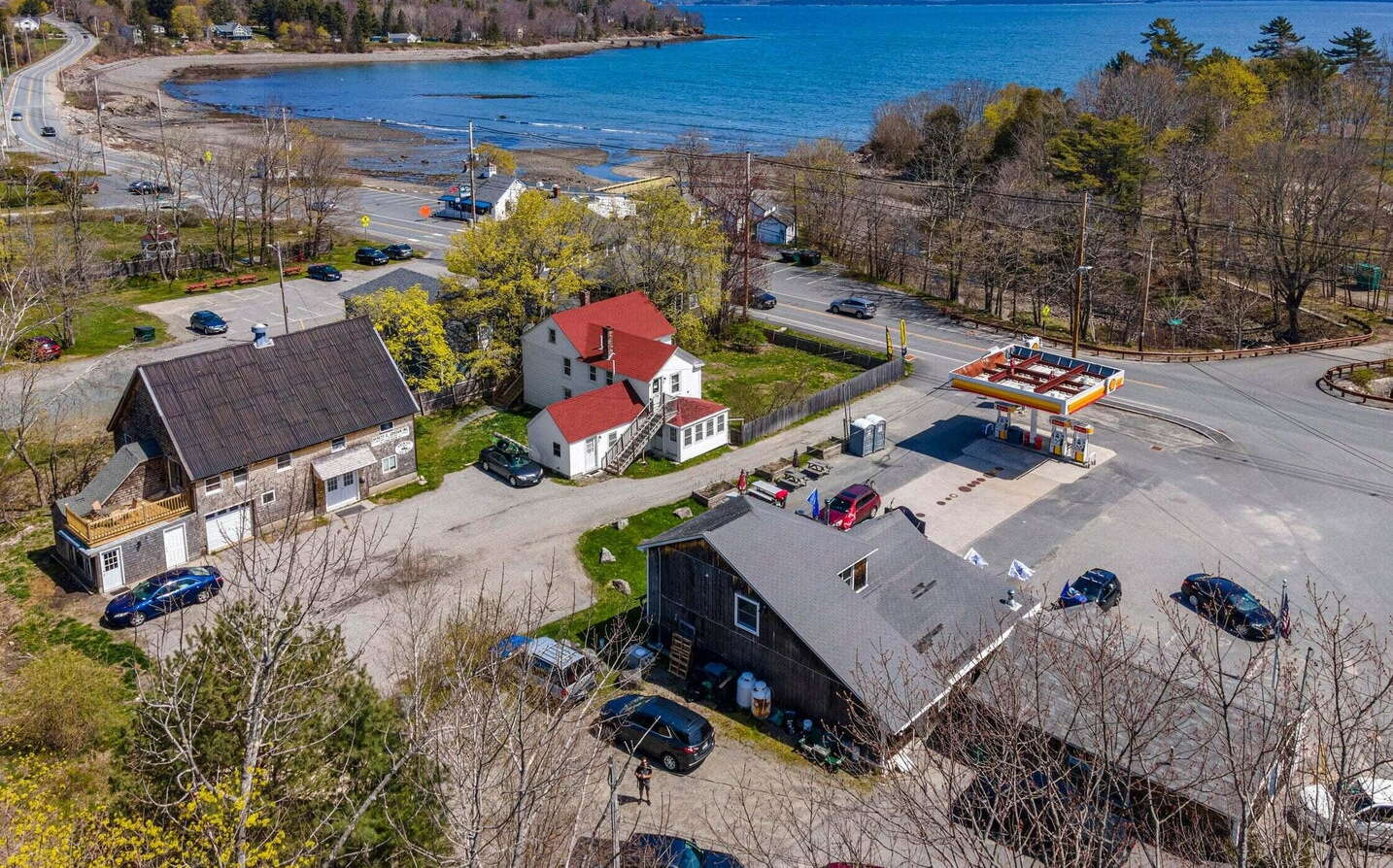 aerial of buildings, road, cars and water