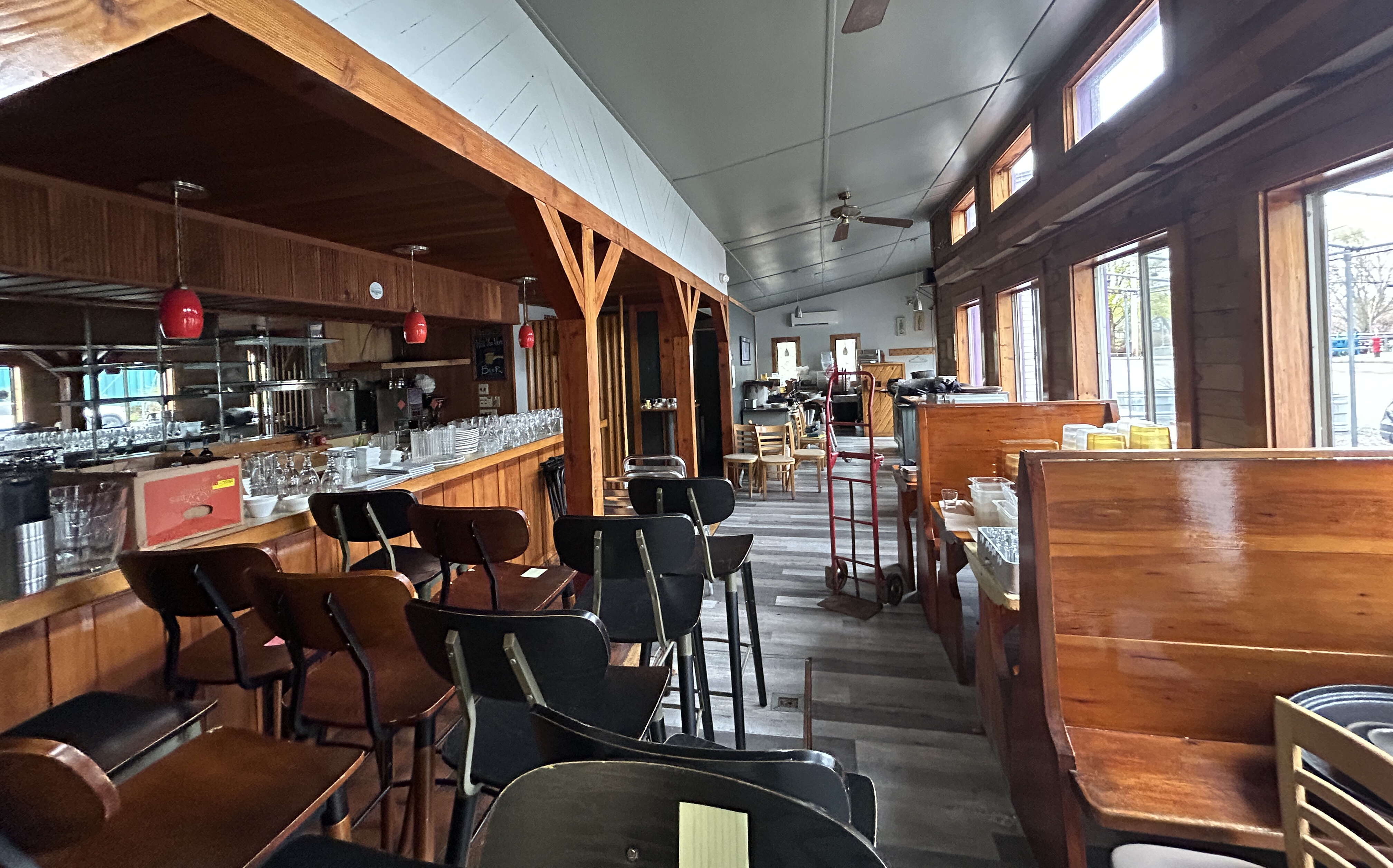 The former restaurant's dining area is full of booths and chairs but is being dismantled.