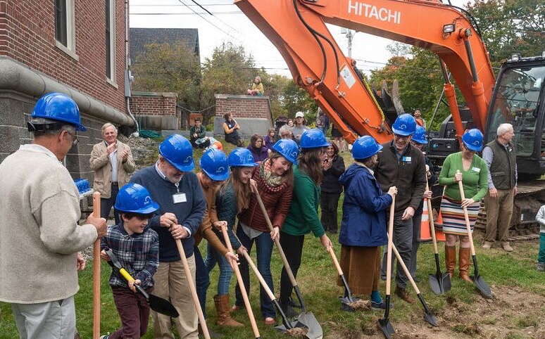 people lined up over shovels