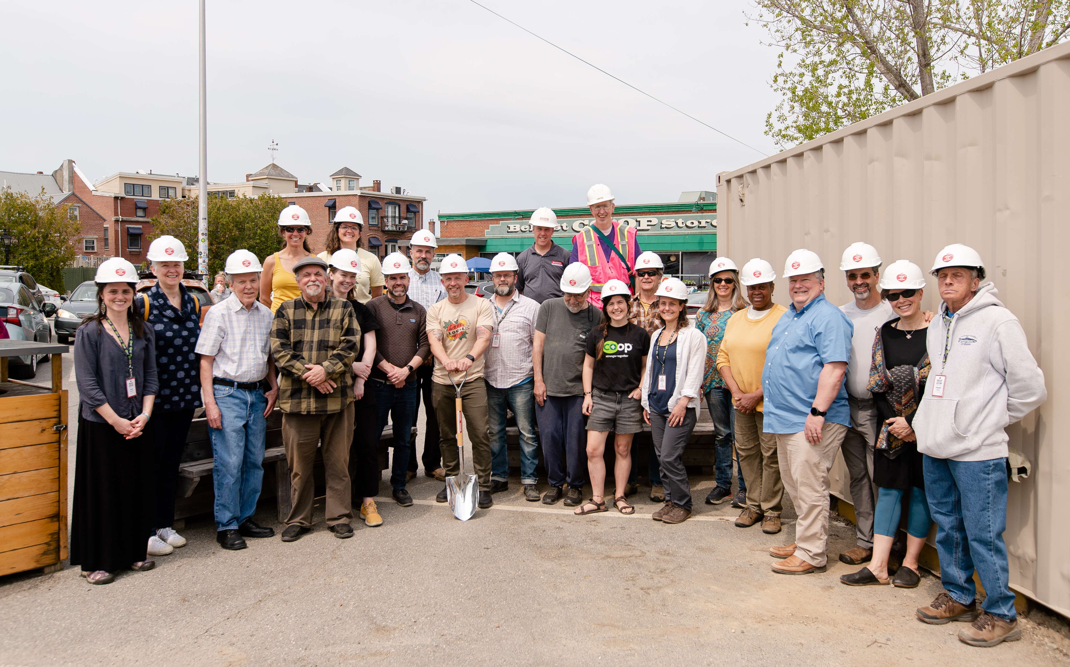 A group of people gather for the groundbreaking at the Belfast coop.