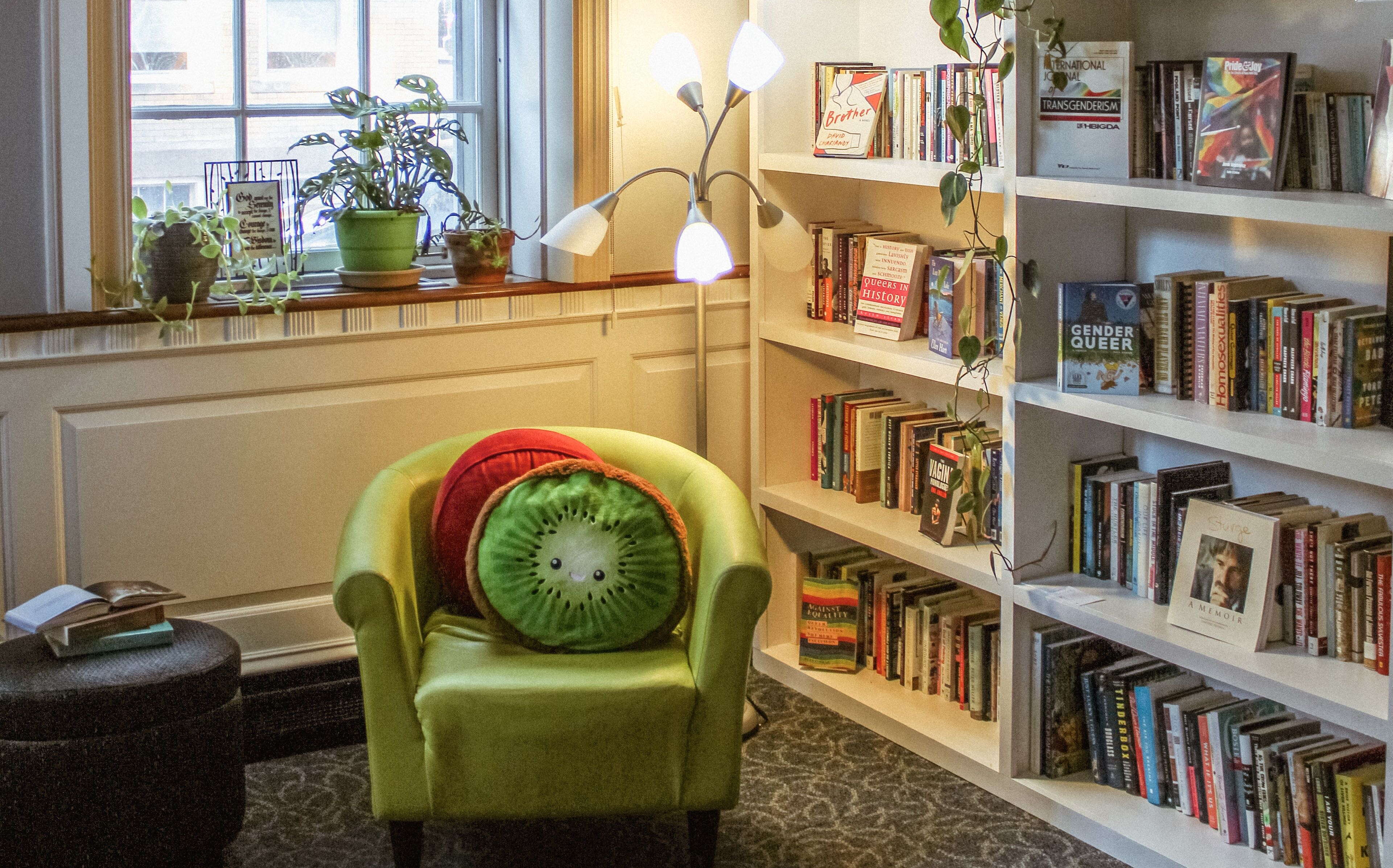 The reading room at the Equality Community Center includes a padded chair and shelves full of books.
