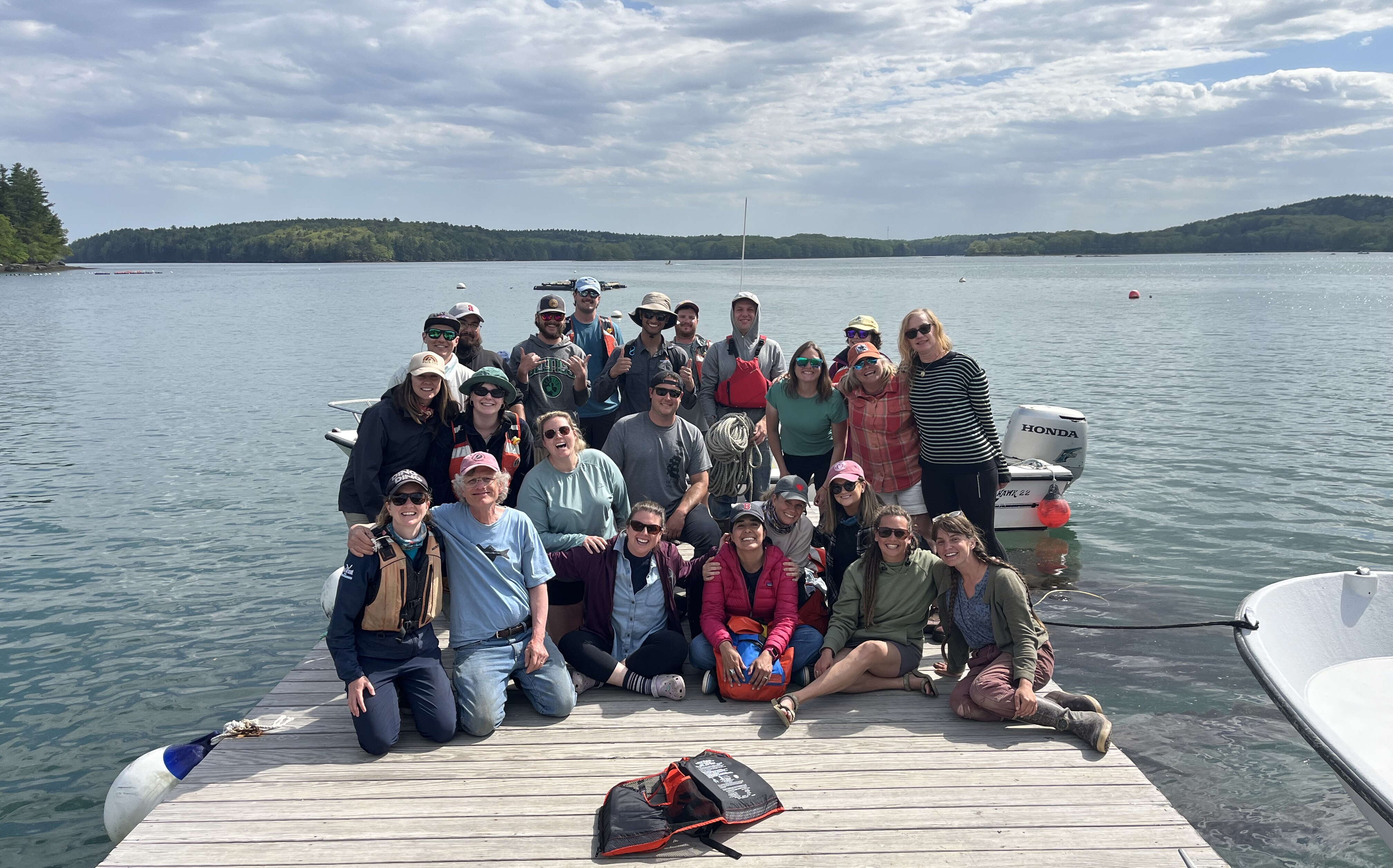 Students in the aquaculture boot camp pose in a group on a dock.