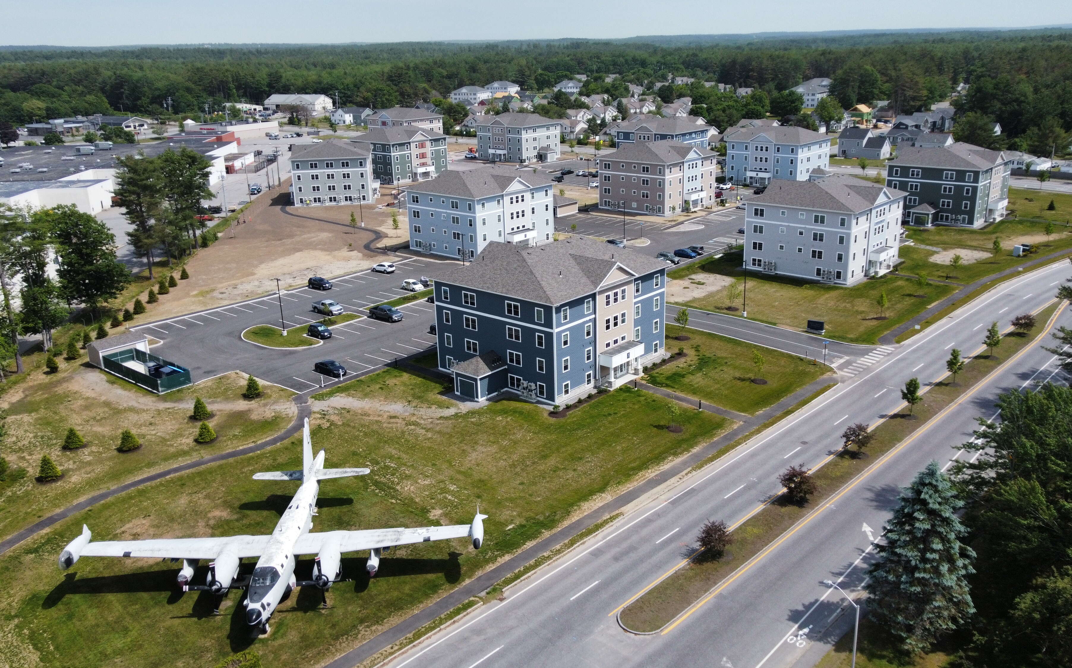 This aerial view shows buildings and a plane at Brunswick Landing.