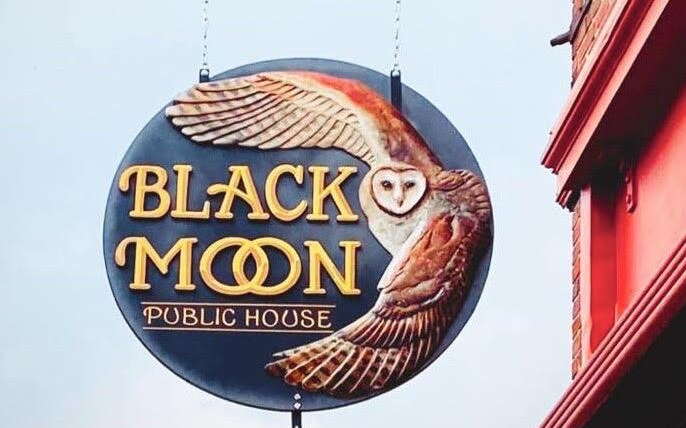 Black Moon's sign hangs outside.