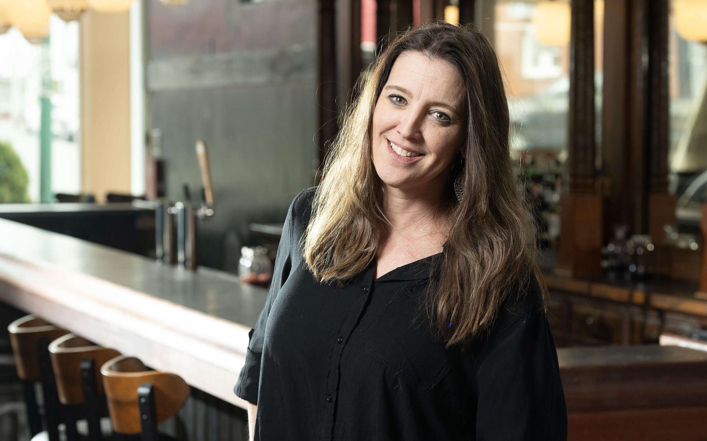 The Black Moon owner stands by the bar.