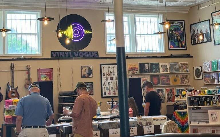 At Vinyl Vogue, people look at records on display racks.