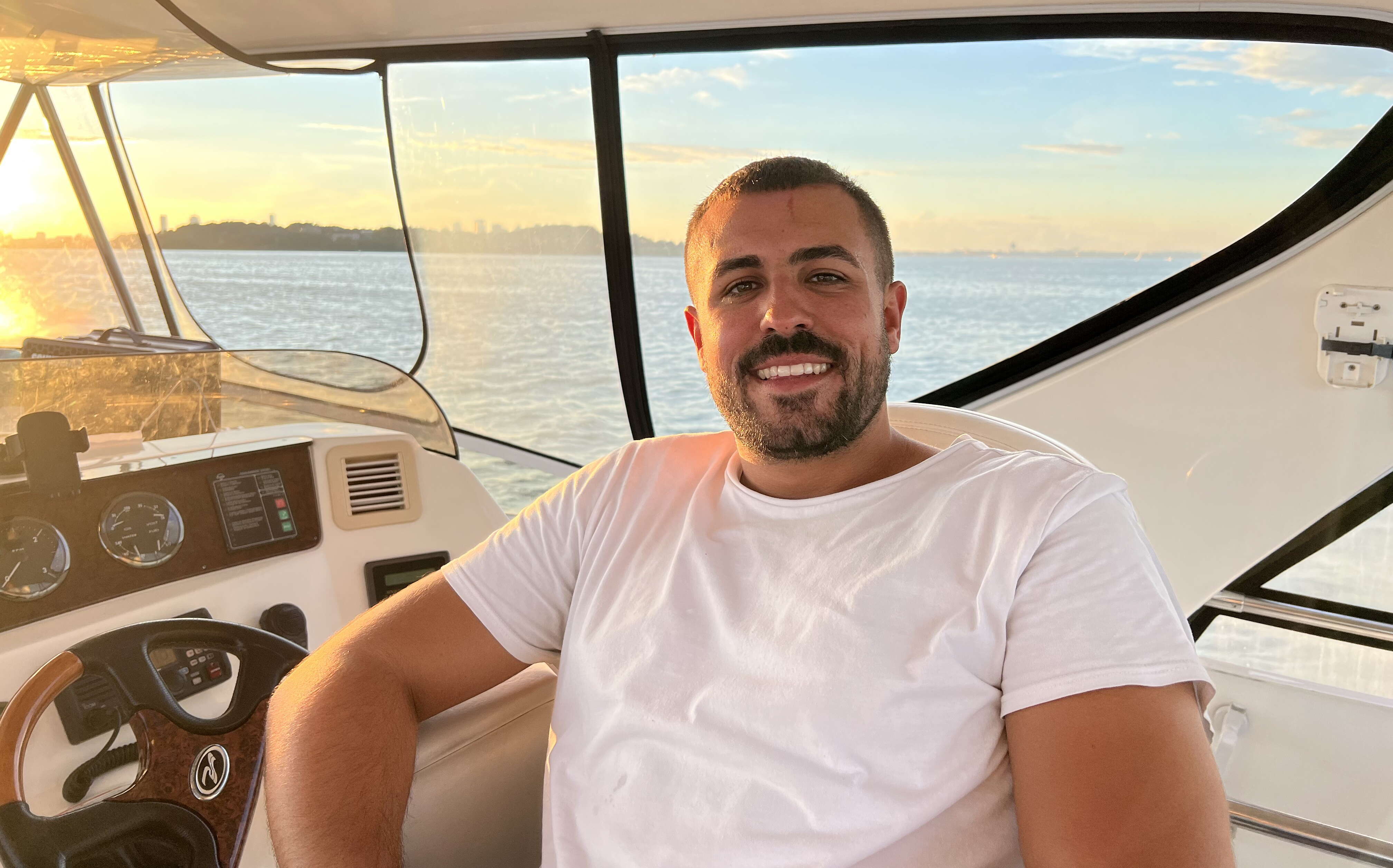 The campground's buyer sits at the helm of a boat.