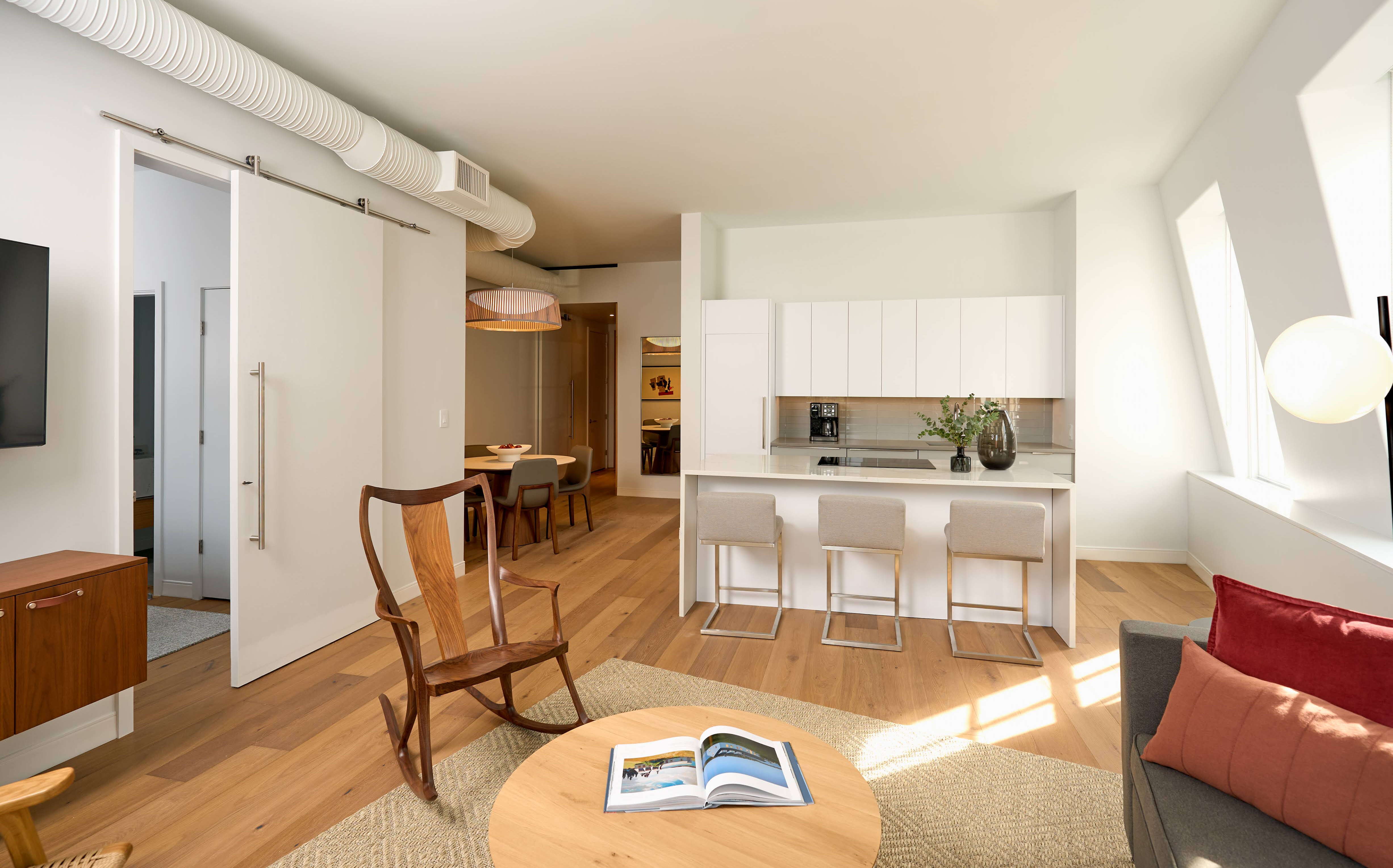 A living room with white paint and some furnishings.