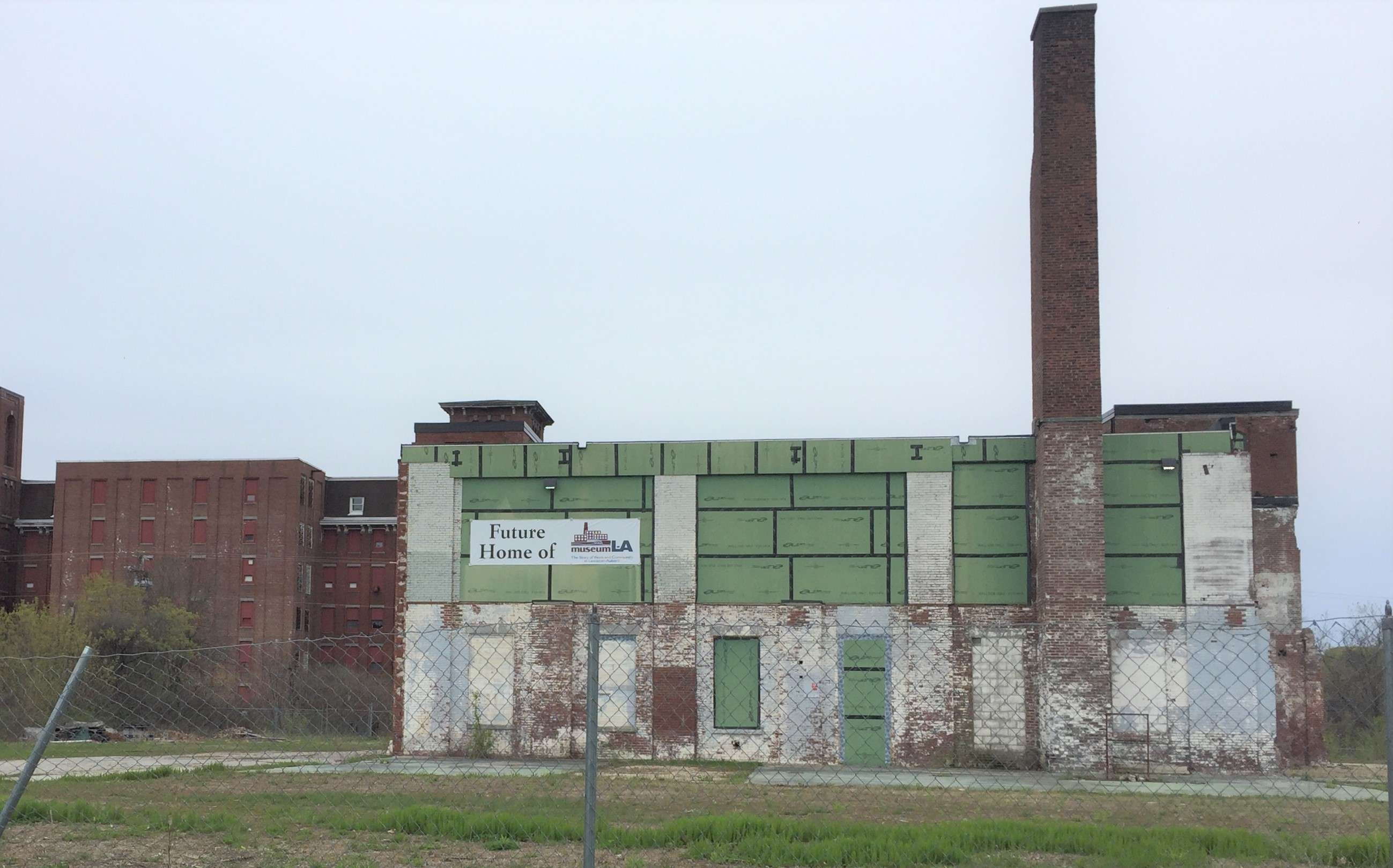 An old mill building is in disrepair.