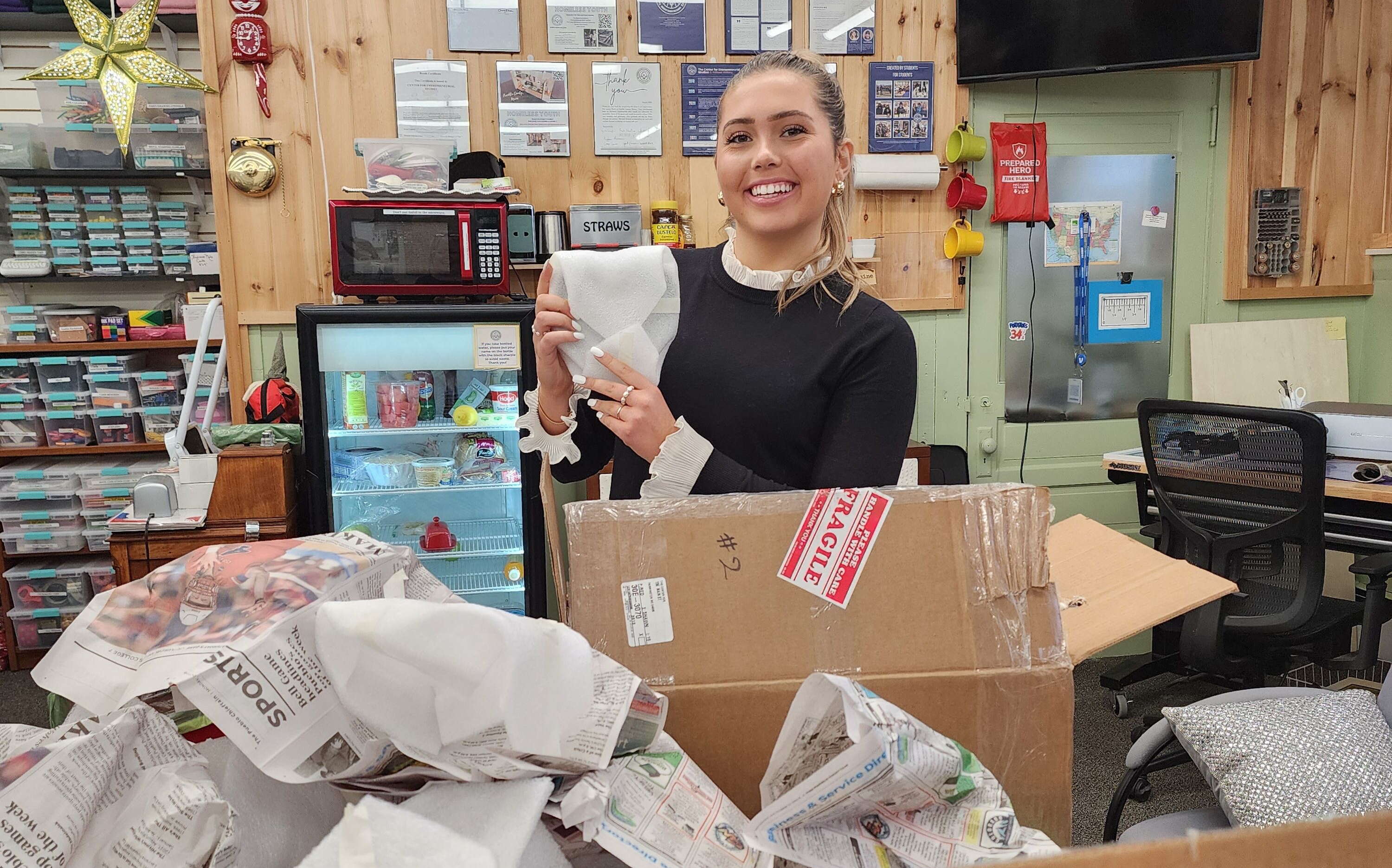 A person opens boxes with wholesale goods.