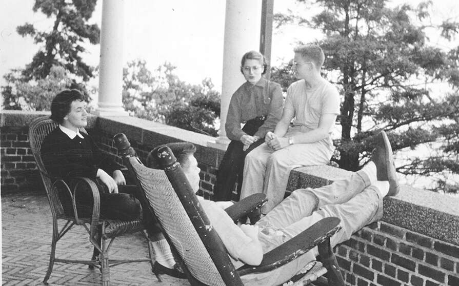 An vintage black-and-white photo shows people relaxing.