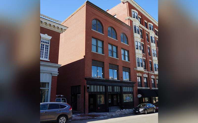 A streeet is lined with brick buildings.