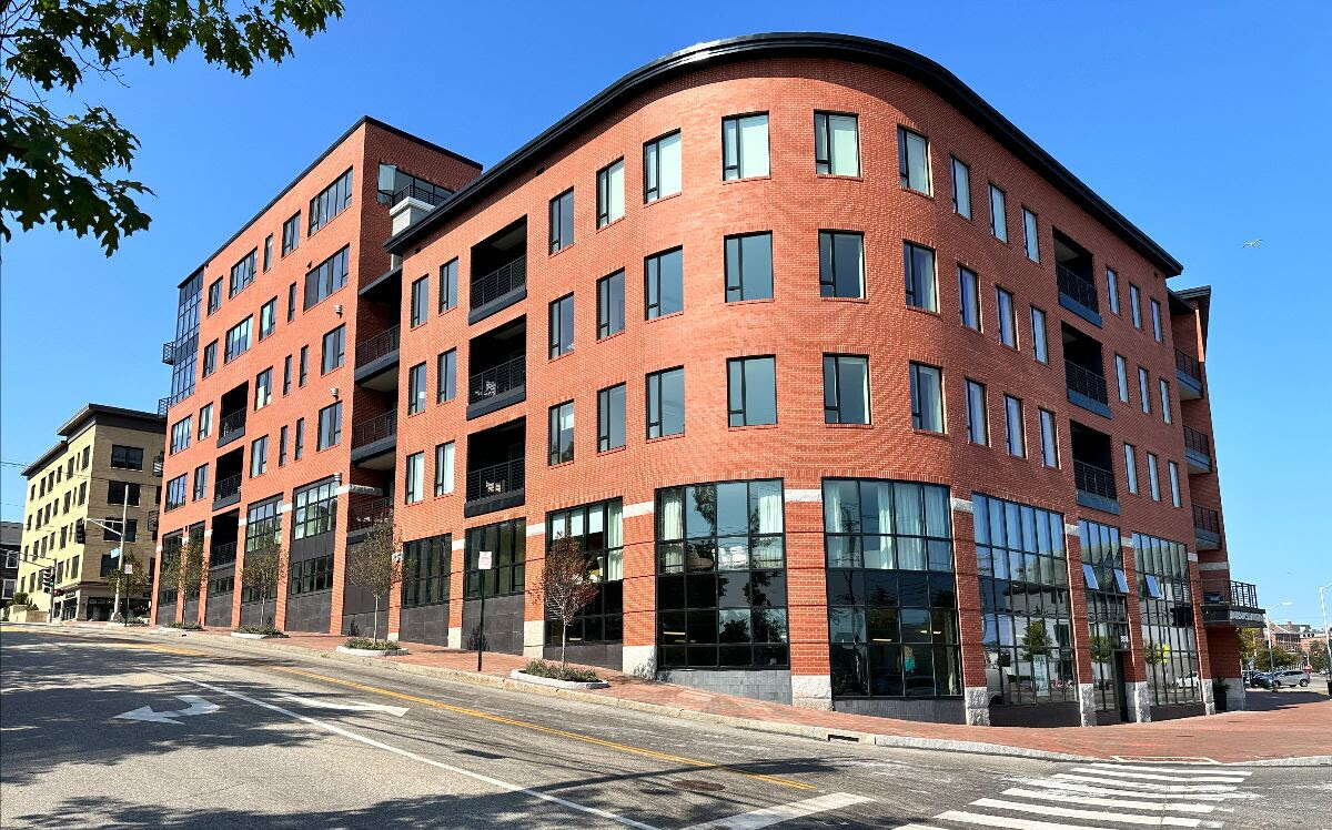 A brick building with a rounded corner.