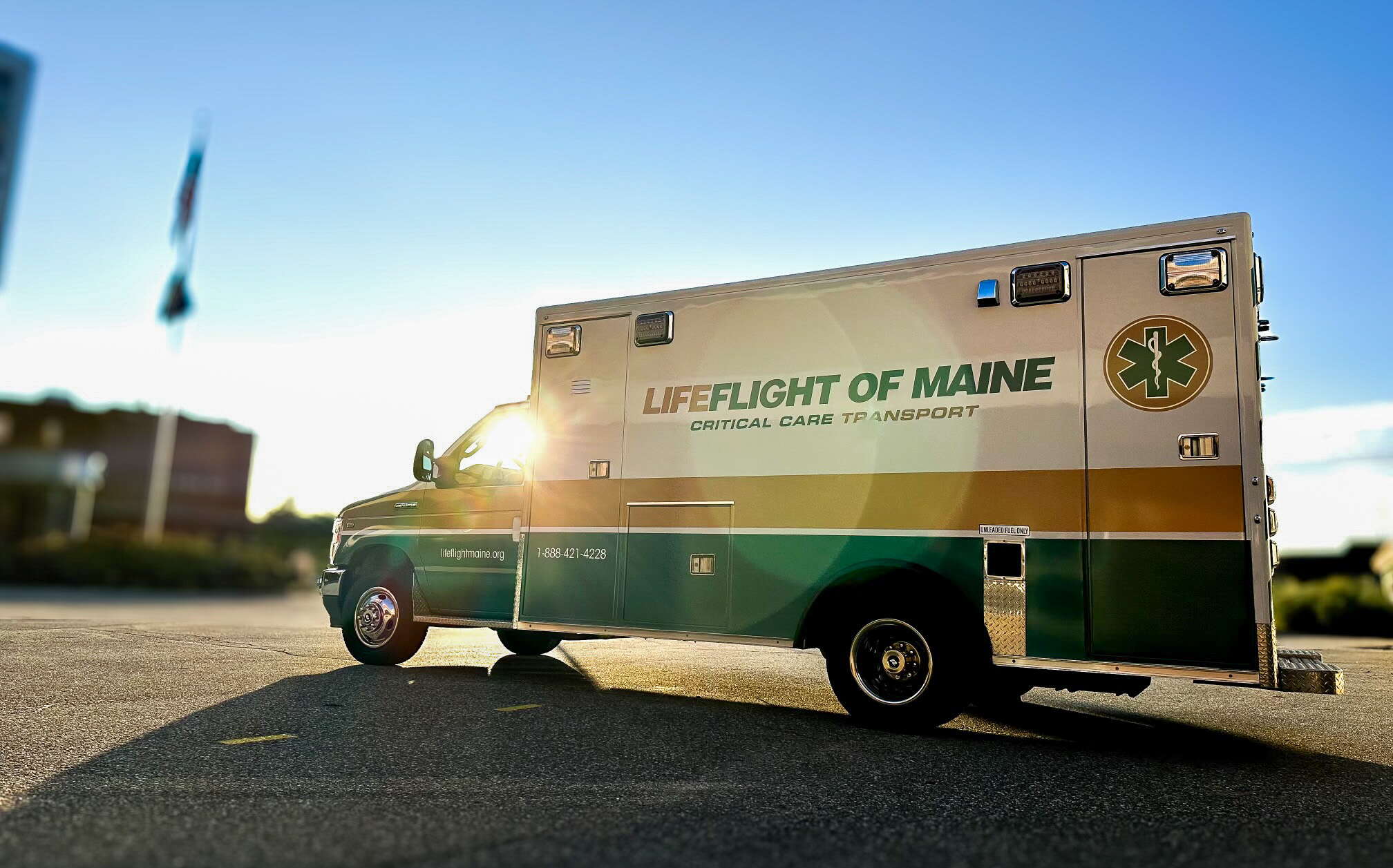 An ambulance gleams in the sun.