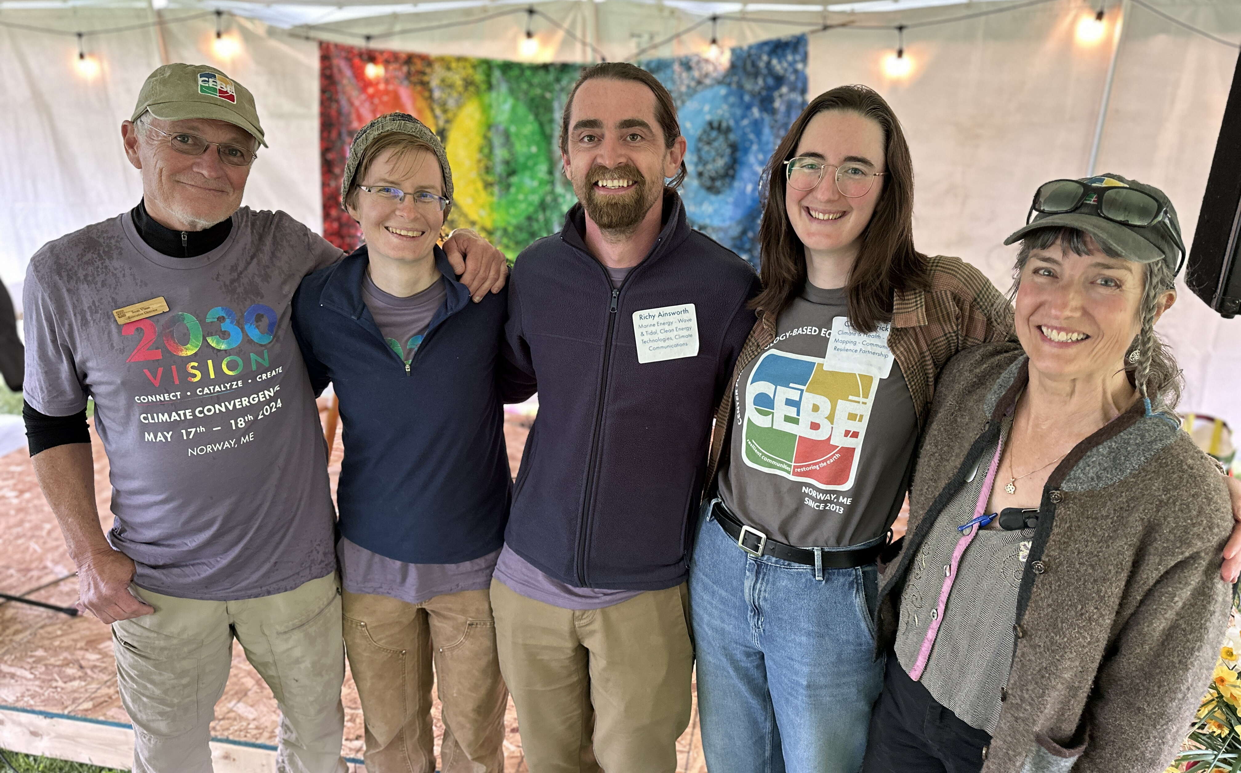 Five people pose for a photo