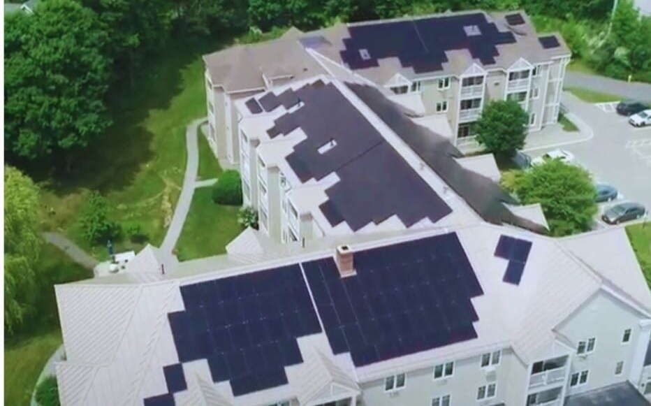 The roofs of buildings have solar panels.