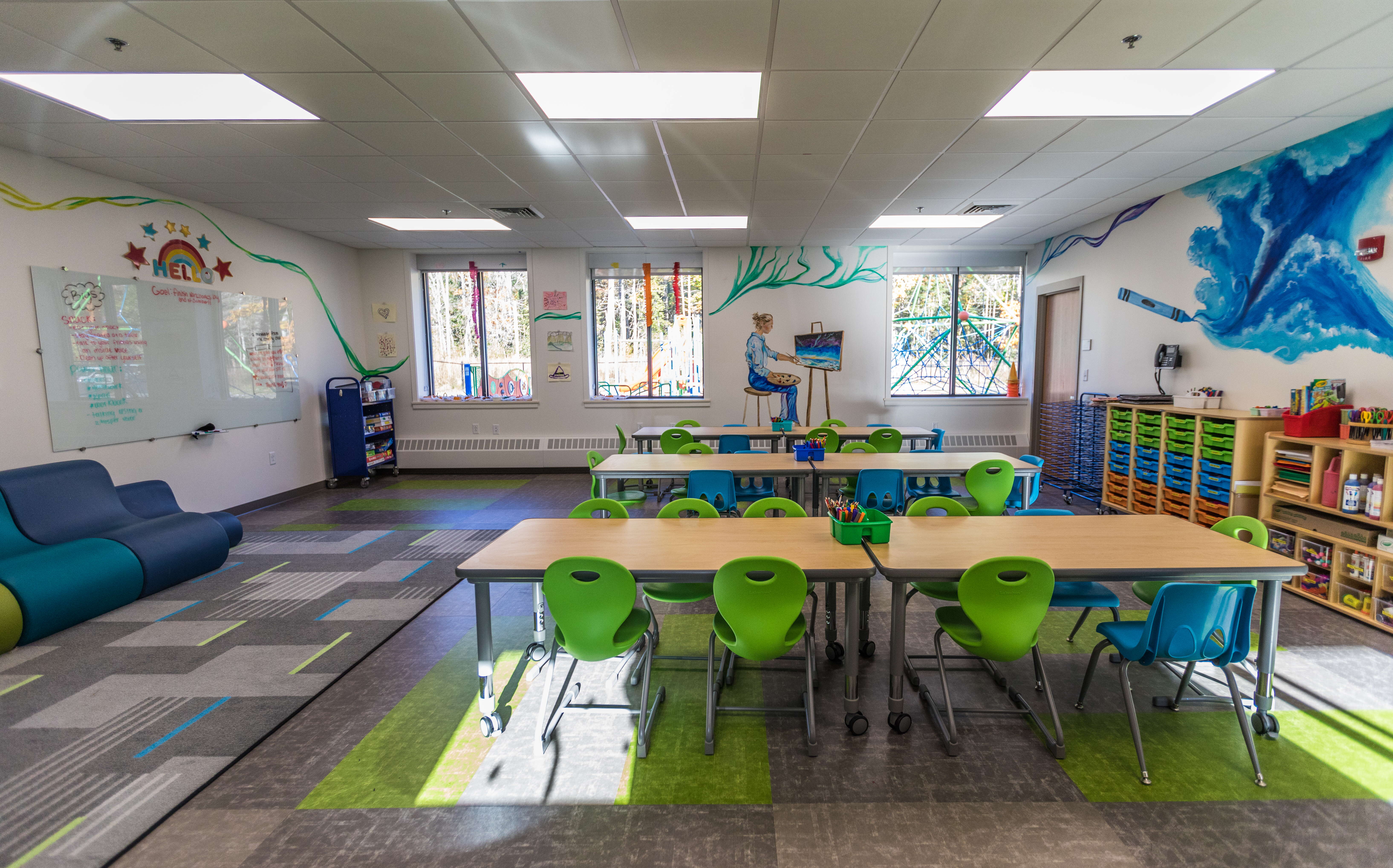 A classroom includes tables and chairs.