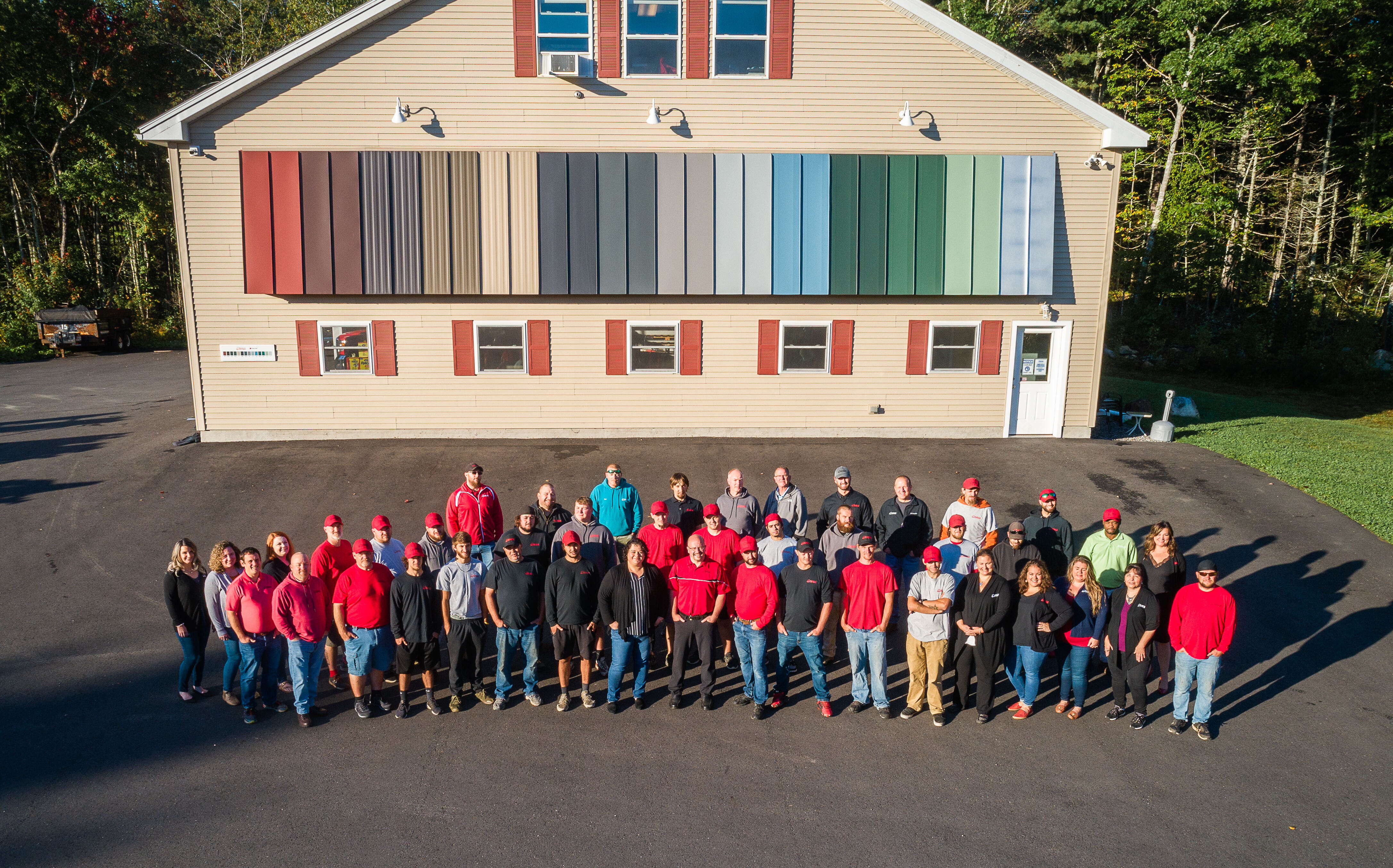 A group of people pose outside of a building.