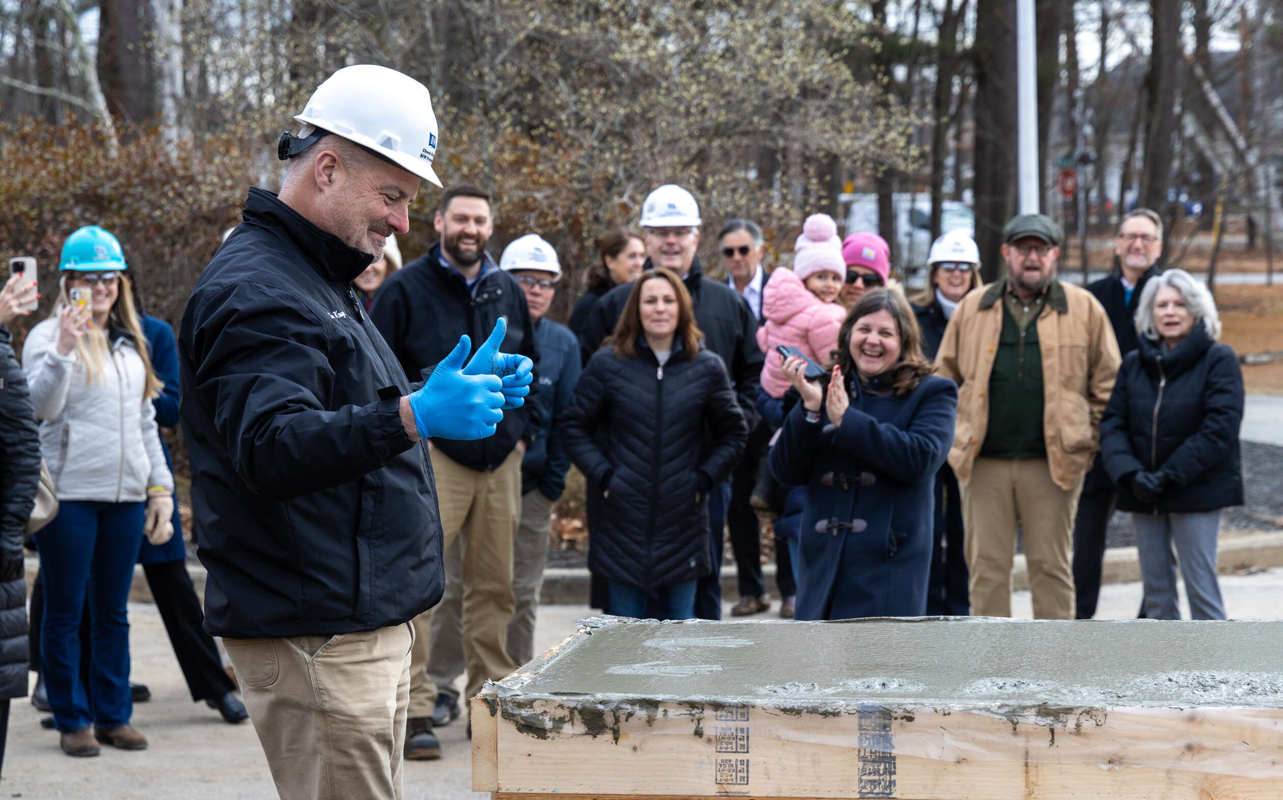 Krugh gives a thumbs up while others look on.