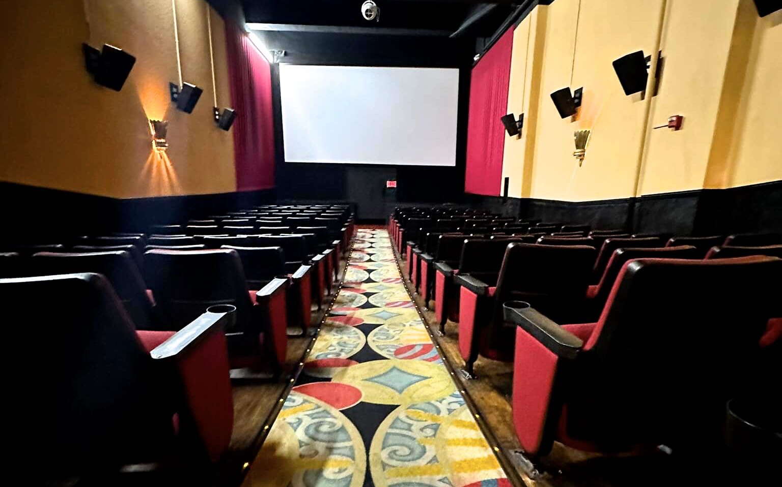 A theater has a screen and seats.