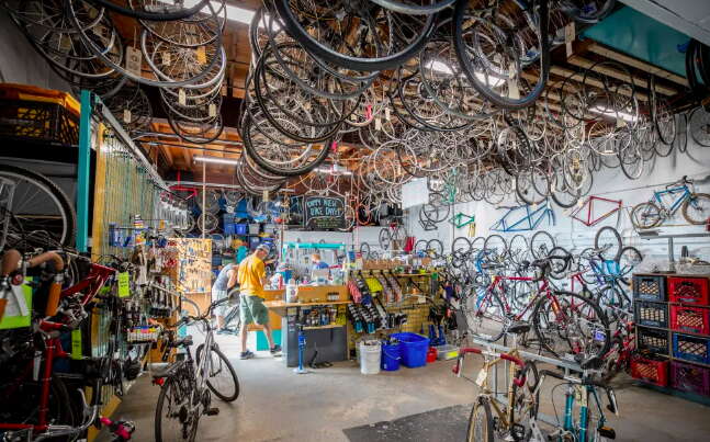 A shop is full of bikes.