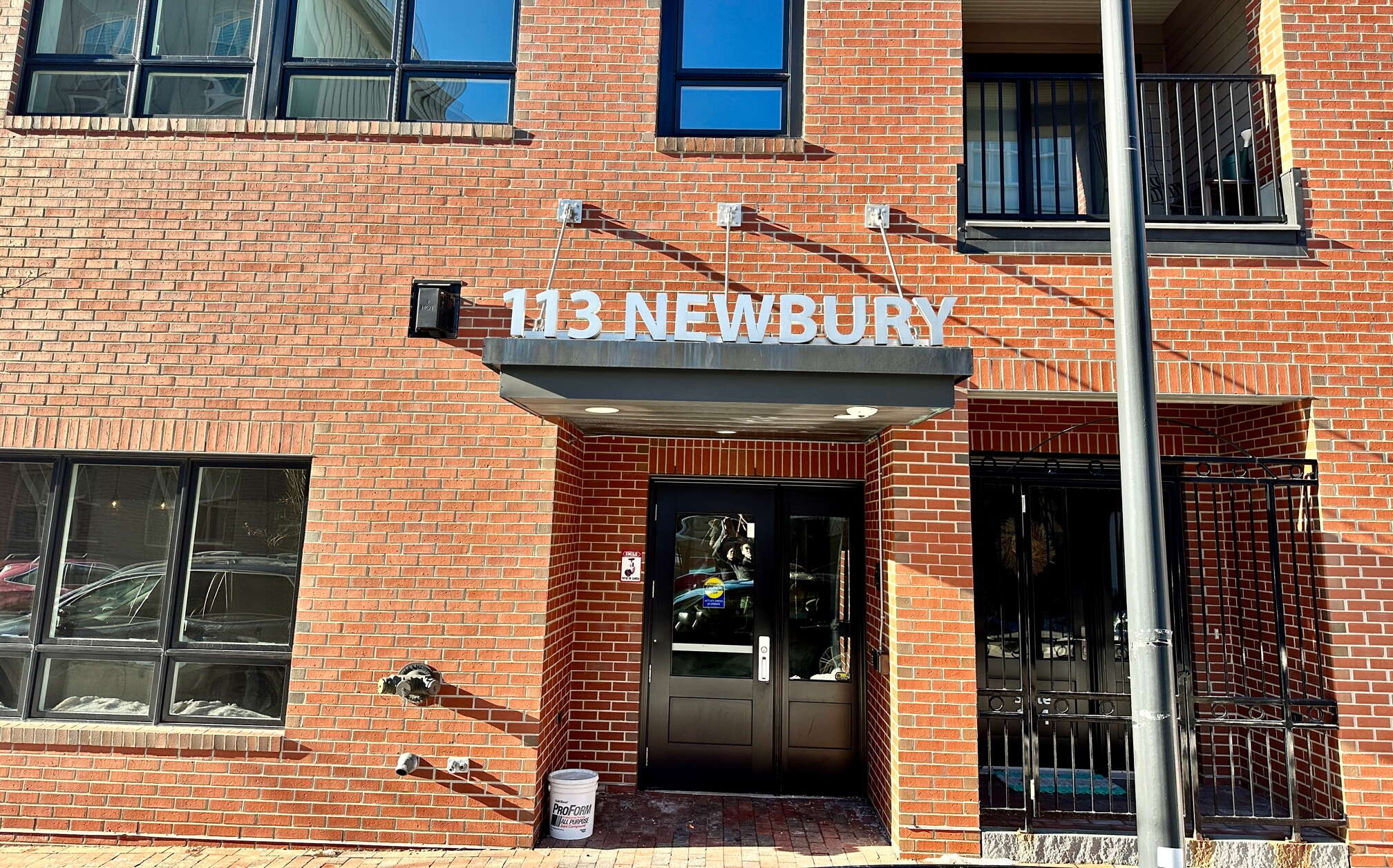 An exterior hoto of a brick building and an entrance.