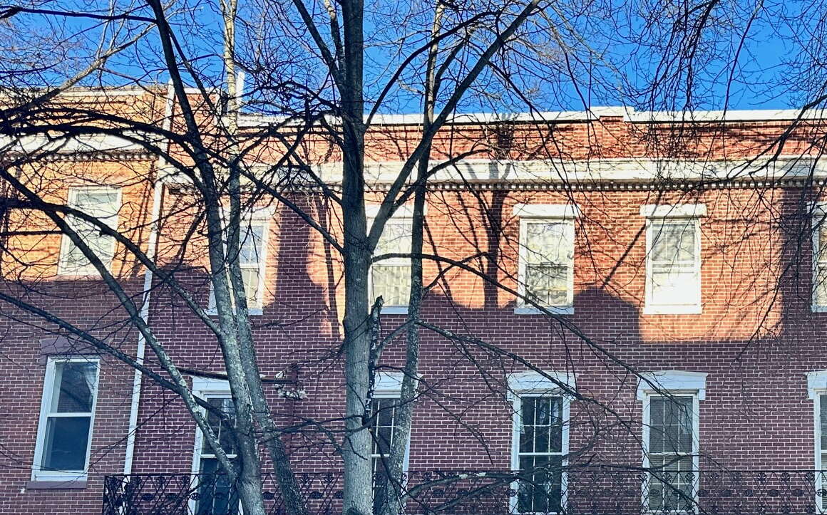 An exterior photo of a brick building with two entrances.