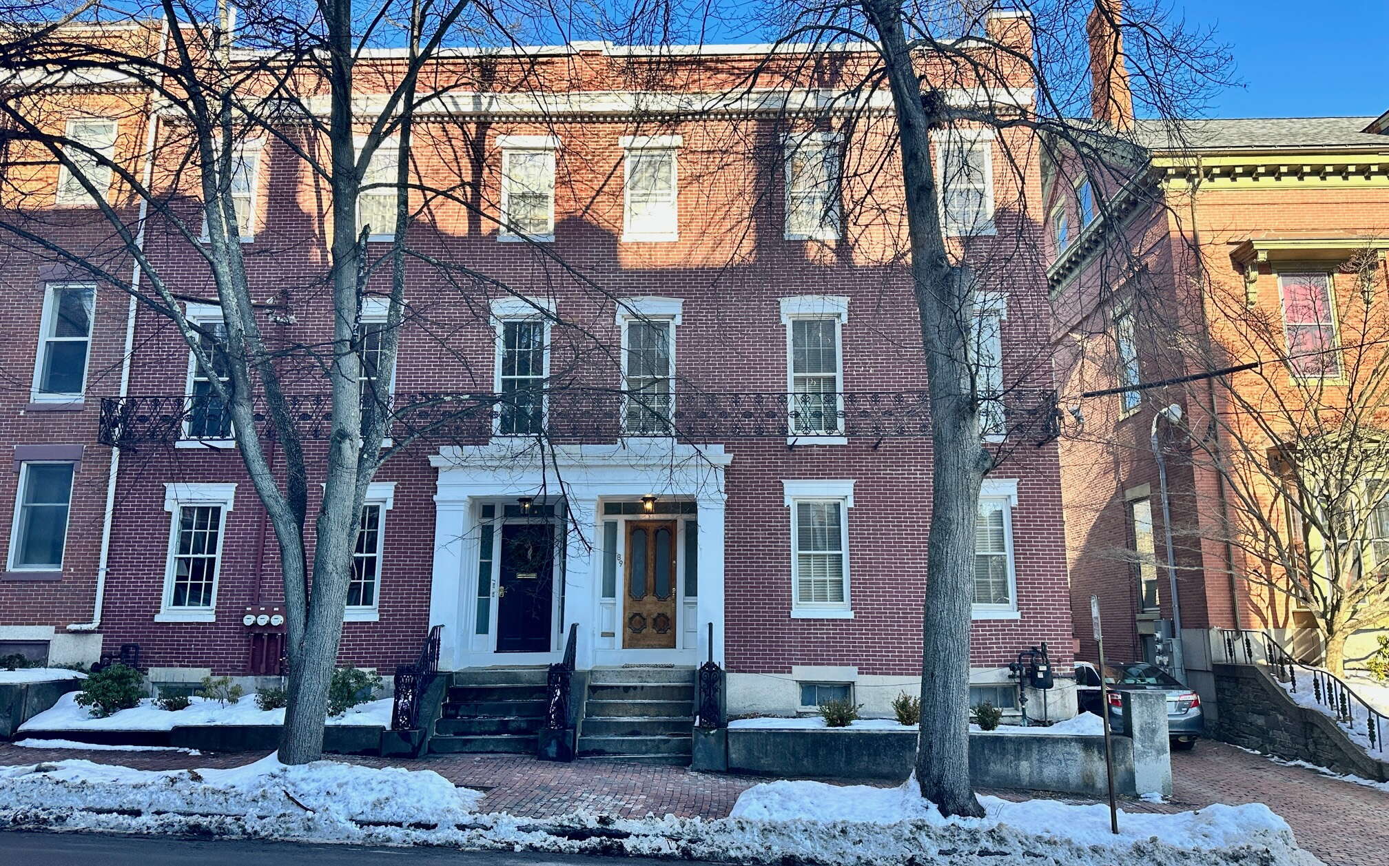 An exterior photo of a brick building with two entrances.