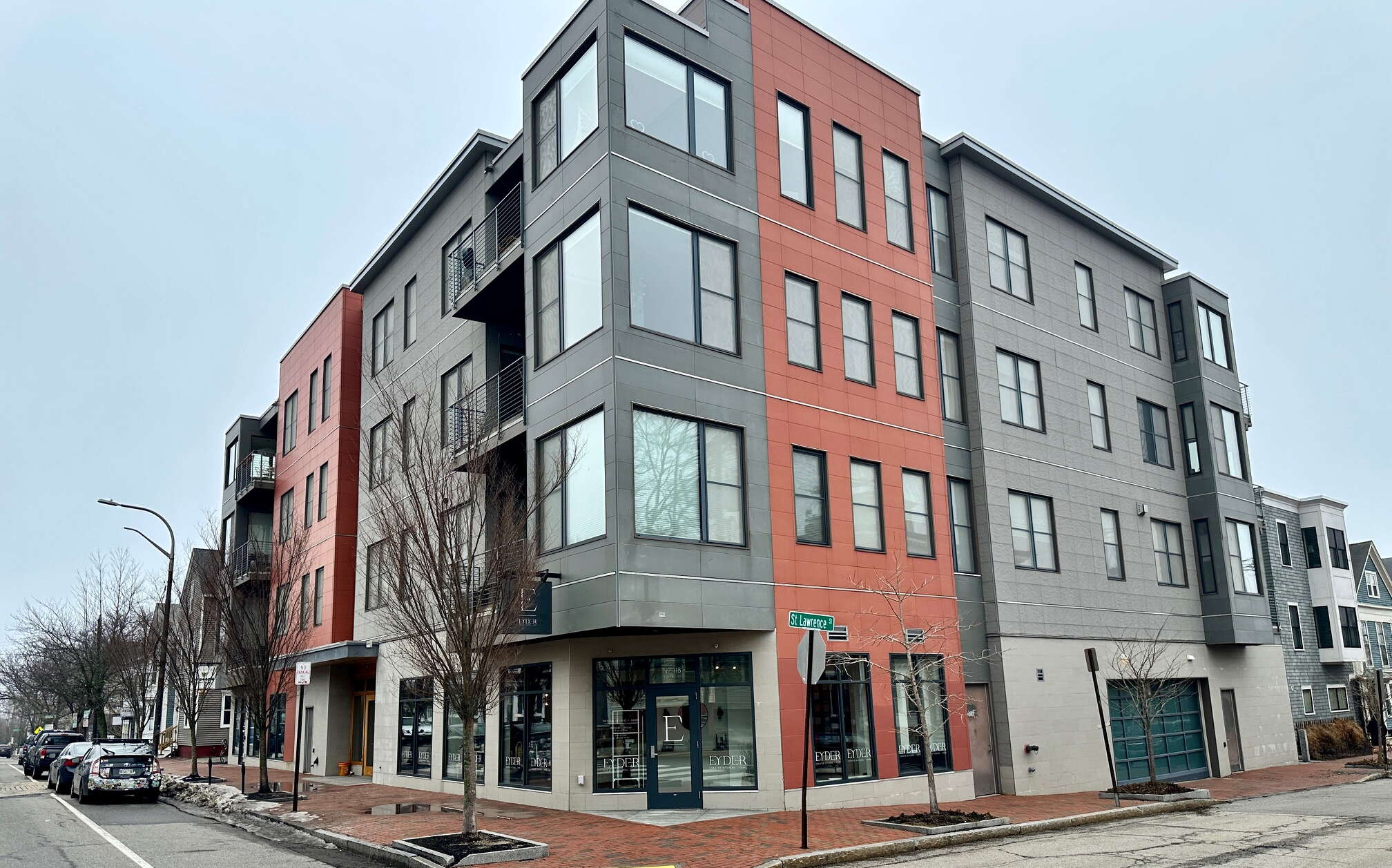 A four-story building stands on a street corner.