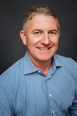 head-and-shoulders picture of man in blue and white shirt