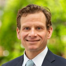 smiling person in suit and tie