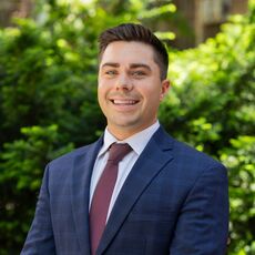 person in suit and tie smiling