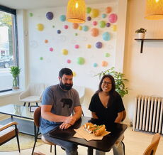 Two people inside a restaurant. 