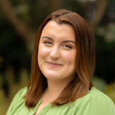 person in green blouse smiling