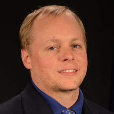 Matthew Burns is seen in a headshot.