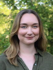 A person poses for a headshot.