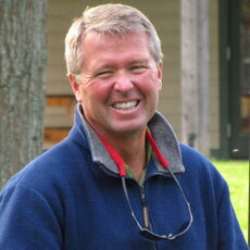 Person smiles while posing for a headshot.