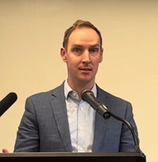 A person stands at a podium.